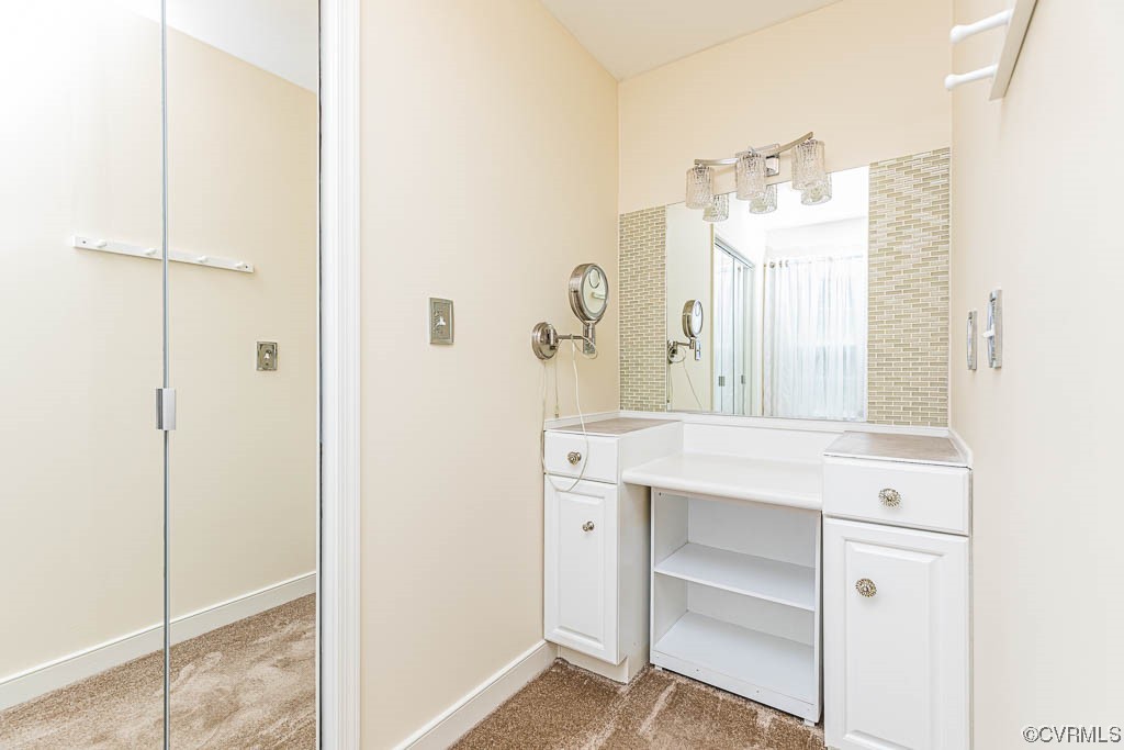 3400 Wood Dale Road Chester, VA 23831 - Photo 18 of 32 a bathroom with a sink mirror and a shower
