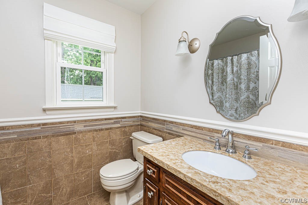 3400 Wood Dale Road Chester, VA 23831 - Photo 24 of 32 a bathroom with a granite countertop toilet a sink and a mirror