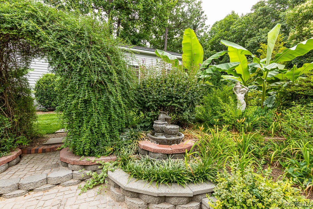 3400 Wood Dale Road Chester, VA 23831 - Photo 28 of 32 a view of a swimming pool with some plants and a fountain