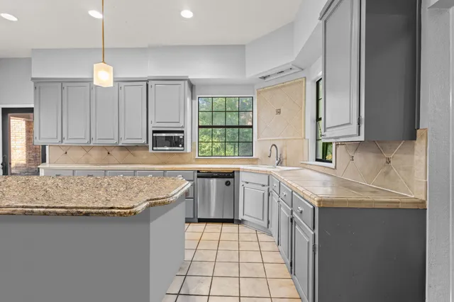 a kitchen with a sink stove and cabinets