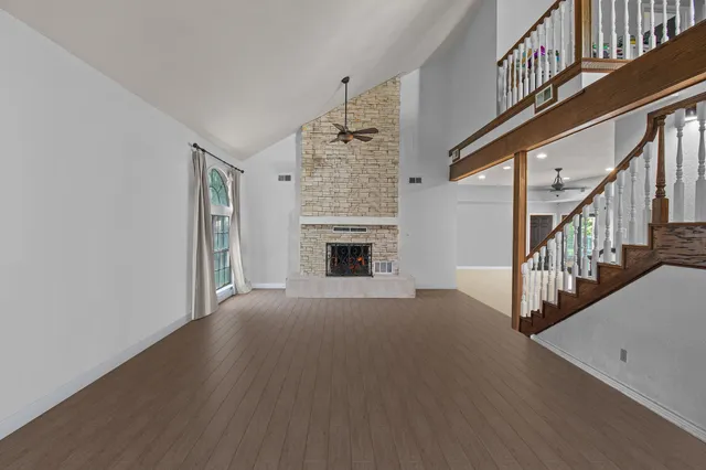 wooden floor in an empty room with a fireplace