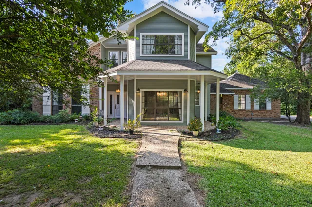 a front view of a house with yard and green space