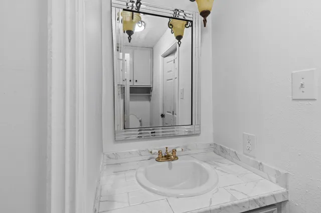 a bathroom with a sink and a mirror