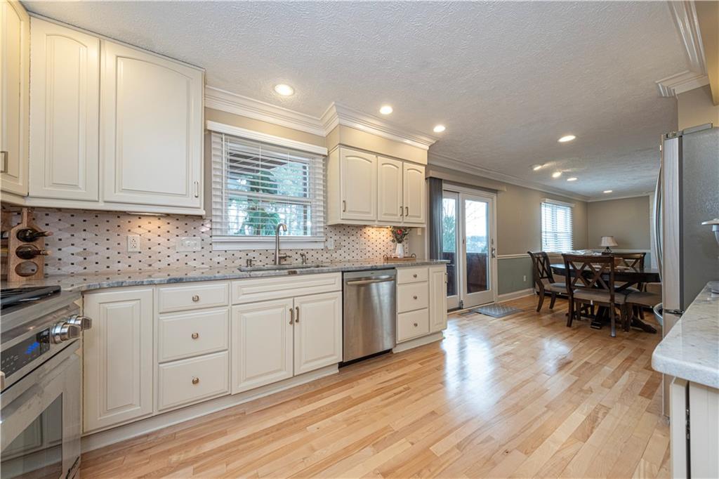 602 Hemlock Road Coraopolis, PA 15108 - Photo 11 of 40 a kitchen with granite countertop white cabinets sink and chairs