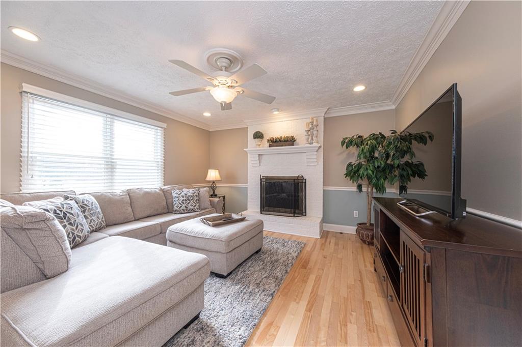 602 Hemlock Road Coraopolis, PA 15108 - Photo 14 of 40 a living room with furniture a flat screen tv and a fireplace