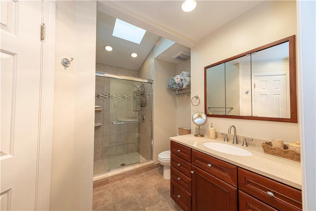 602 Hemlock Road Coraopolis, PA 15108 - Photo 21 of 40 a bathroom with a shower sink vanity and mirror