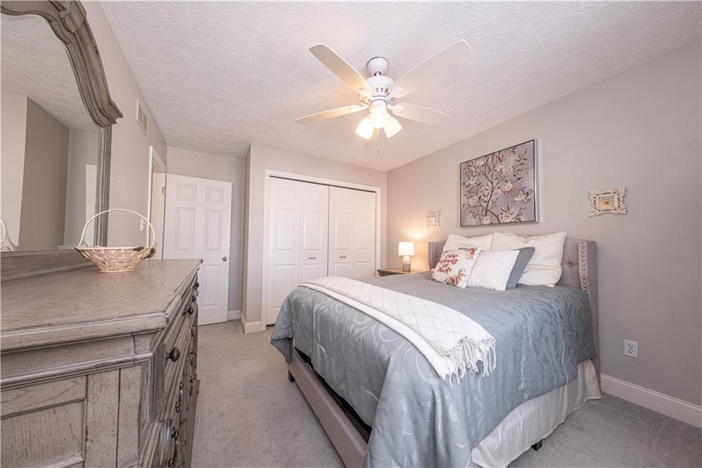 602 Hemlock Road Coraopolis, PA 15108 - Photo 23 of 40 a bedroom with a large bed and a chandelier