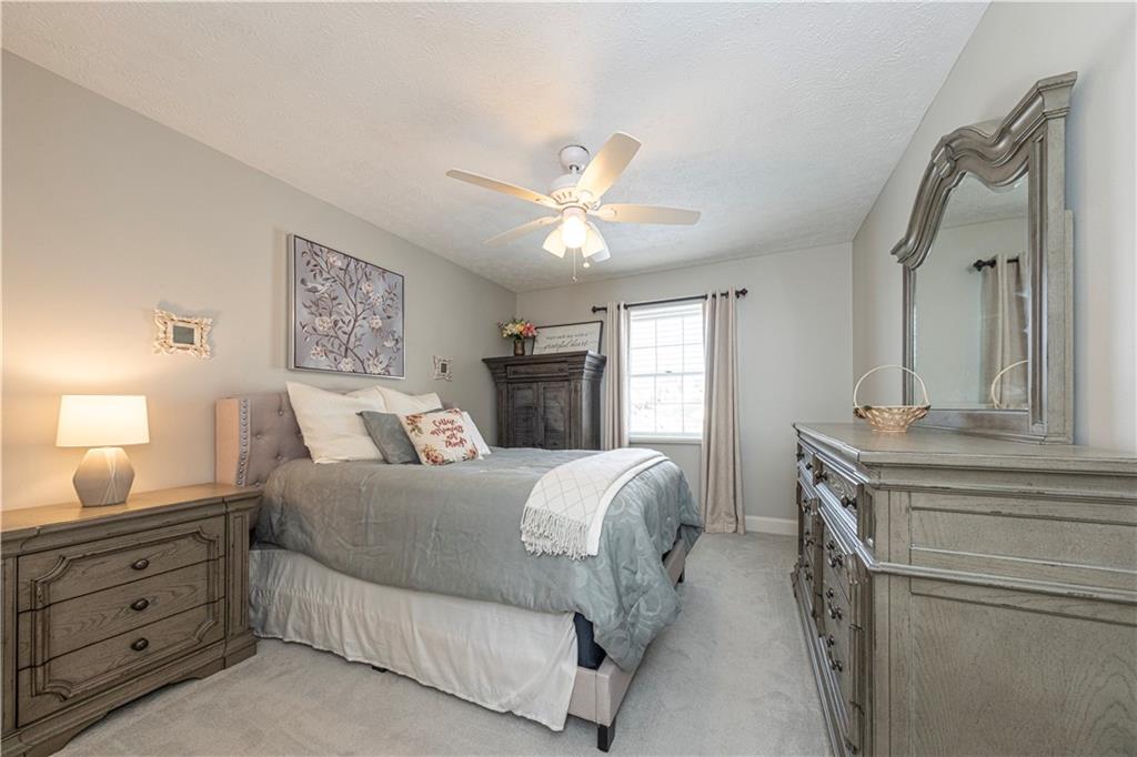 602 Hemlock Road Coraopolis, PA 15108 - Photo 24 of 40 a spacious bedroom with a large bed and a chandelier