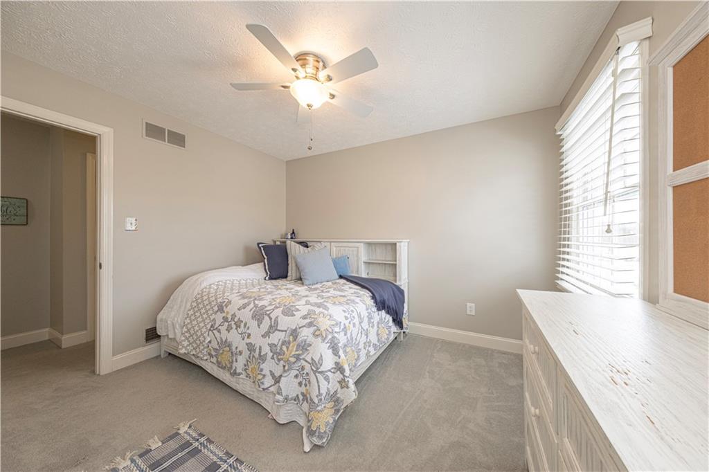 602 Hemlock Road Coraopolis, PA 15108 - Photo 30 of 40 a bedroom with a bed and a chandelier