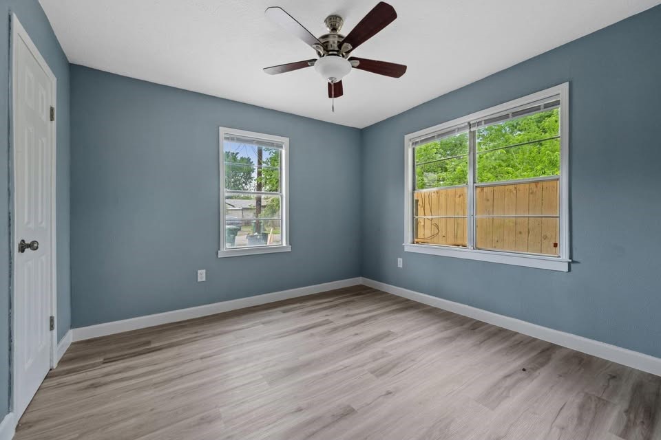 3425 Nettleton Street Houston, TX 77004 - Photo 4 of 12 a view of an empty room with wooden floor and a window