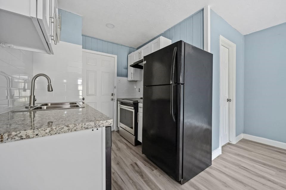 3425 Nettleton Street Houston, TX 77004 - Photo 5 of 12 a kitchen with a refrigerator sink and cabinets