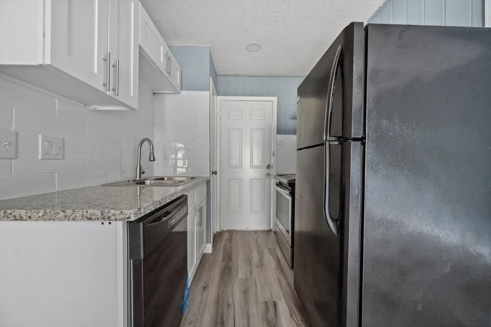 3425 Nettleton Street Houston, TX 77004 - Photo 6 of 12 a kitchen with stainless steel appliances granite countertop a refrigerator and a sink