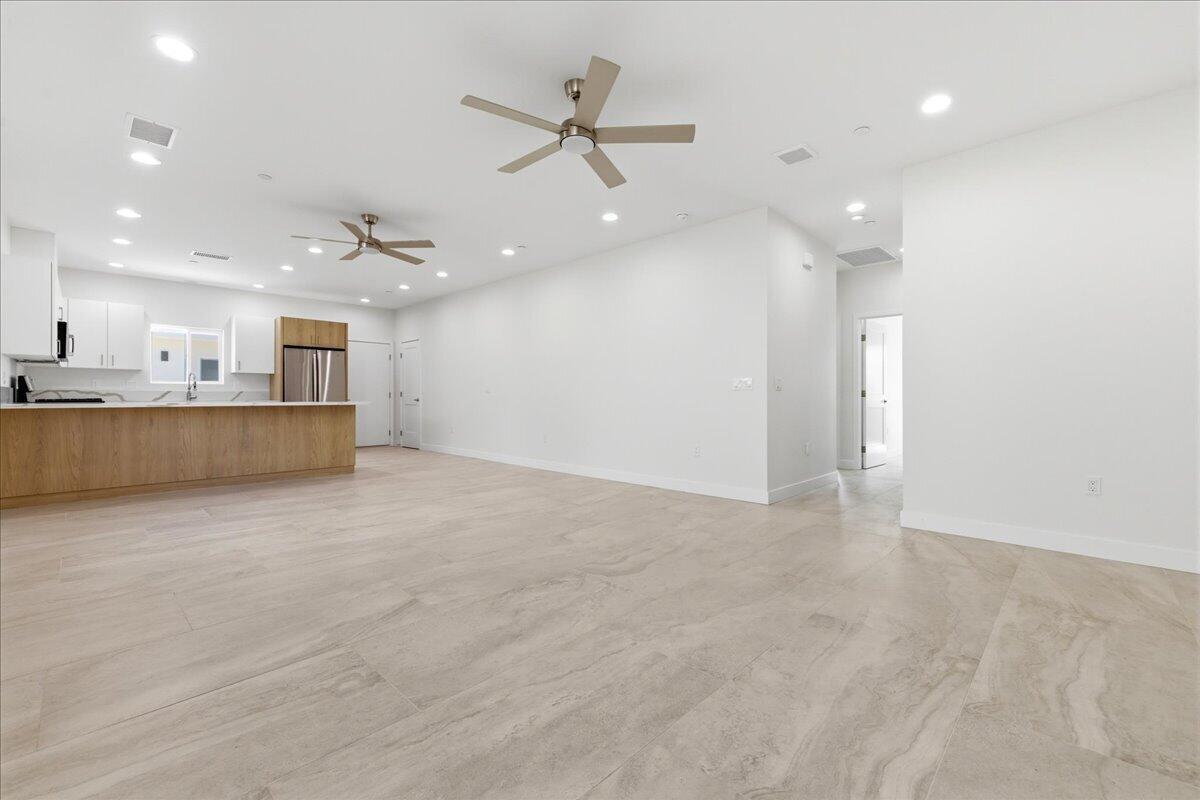 68160 Modalo Road Cathedral City, CA 92234 - Photo 10 of 57 an empty room with a kitchen and a chandelier fan