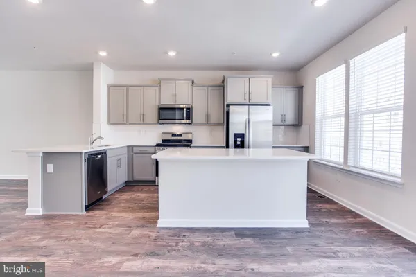 a large kitchen with a center island and a window