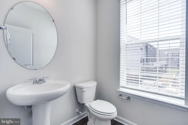 a bathroom with a toilet a sink and a mirror