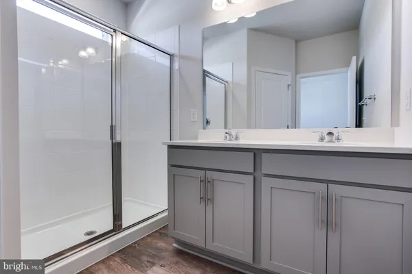 a bathroom with a sink double vanity and a mirror