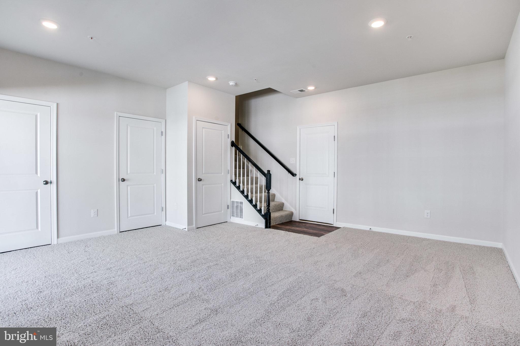 5039 MacDonough Place Frederick, MD 21703 - Photo 33 of 35 a view of an empty room with stairs