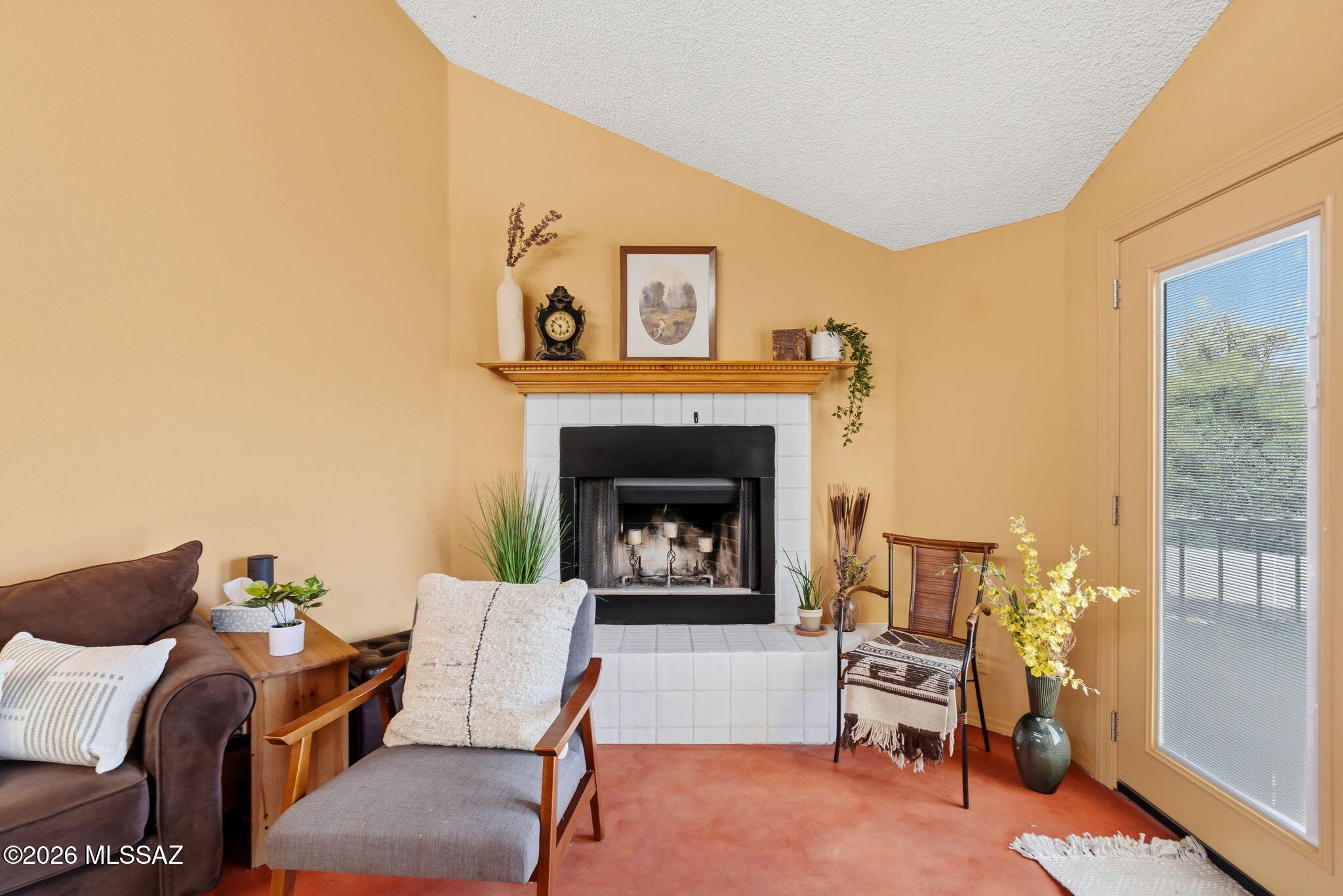 1200 East River Road, Unit G87 Tucson, AZ 85718 - Photo 6 of 30 a living room with furniture and a fireplace