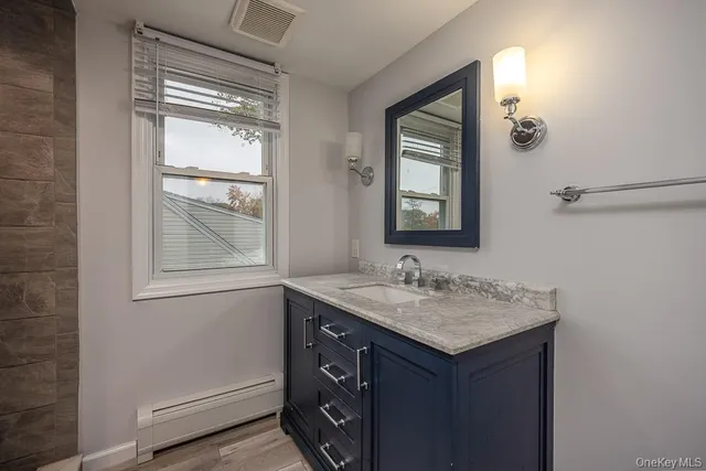a bathroom with a sink a vanity and a mirror
