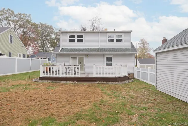 a view of a house with a yard and sitting area