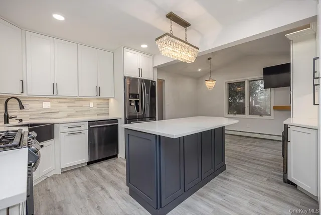 a kitchen with a stove a sink and a refrigerator
