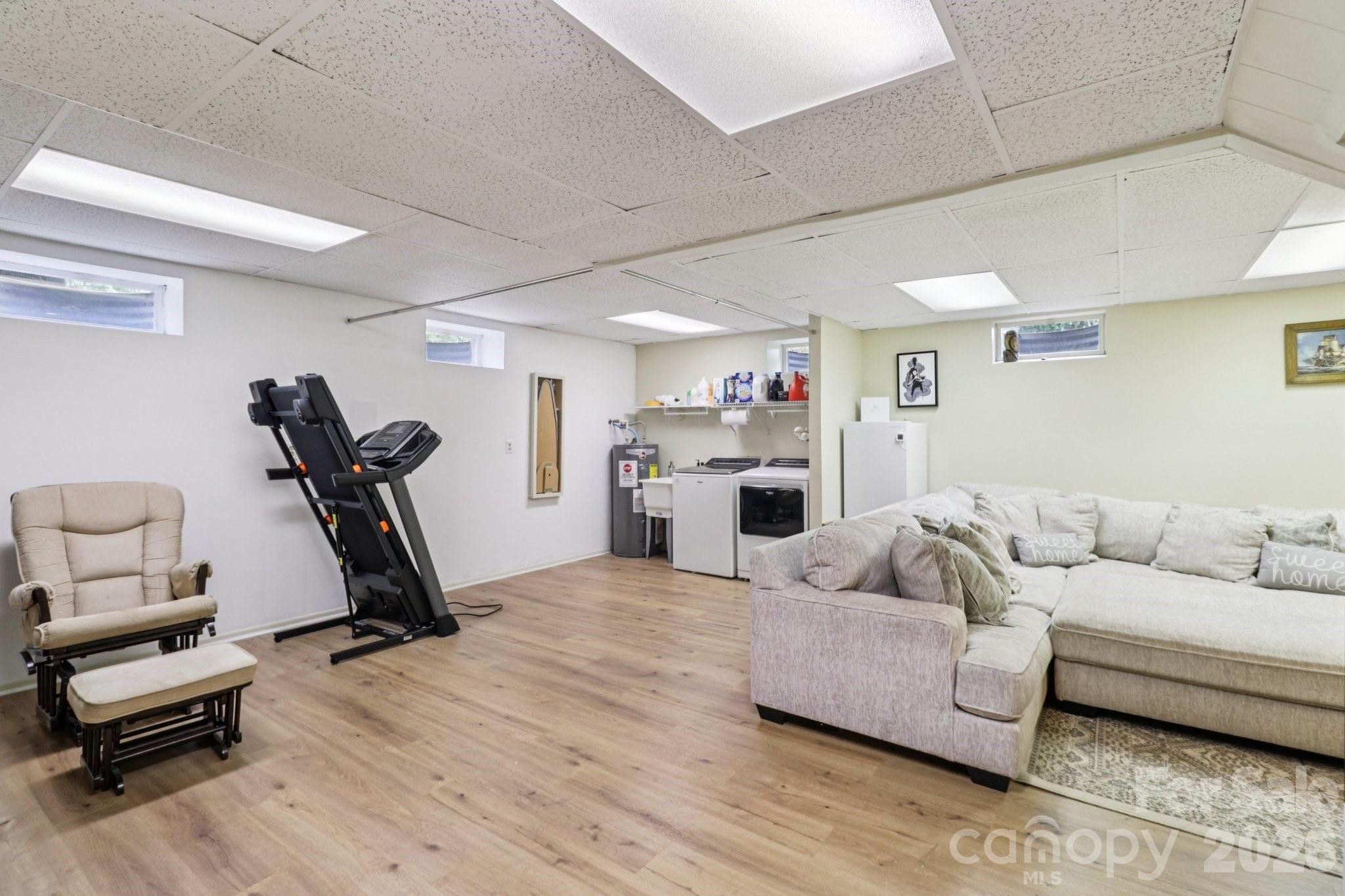 5483 Valley Run Street Hickory, NC 28601 - Photo 32 of 48 a living room with furniture gym equipment and a wooden floor