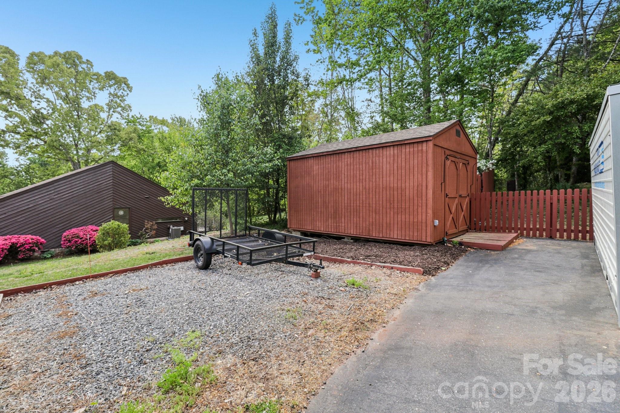 5483 Valley Run Street Hickory, NC 28601 - Photo 42 of 48 a view of a backyard with a large tree and wooden fence