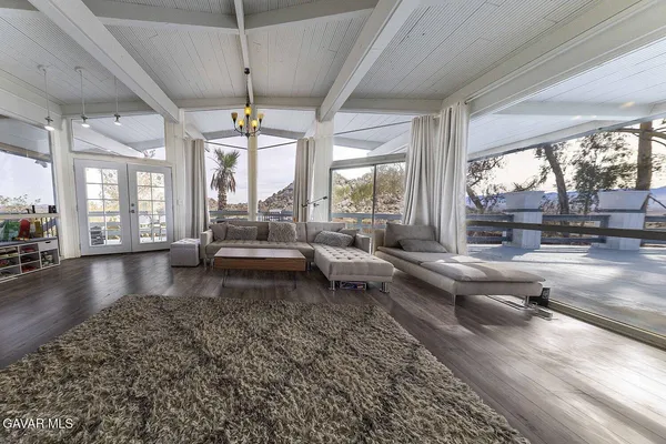 a kitchen that has a lot of cabinets in it and wooden floors