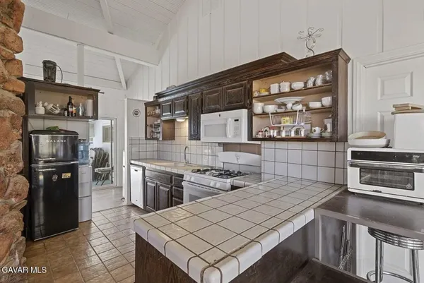 a large bedroom with a large bed and a view of living room