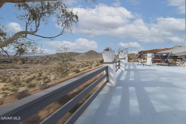 a spacious bedroom with a bed and a wooden floor