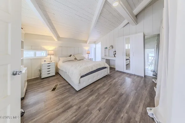 a view of a house with wooden fence