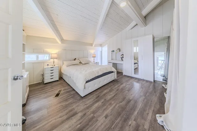 a view of a house with wooden fence