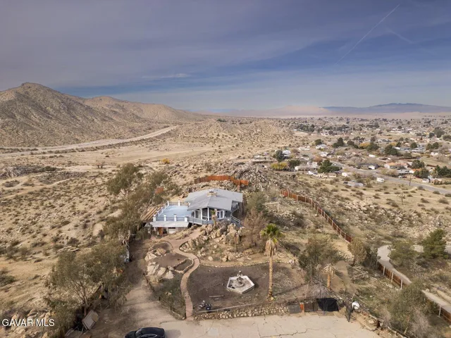 a view of a yard with wooden fence