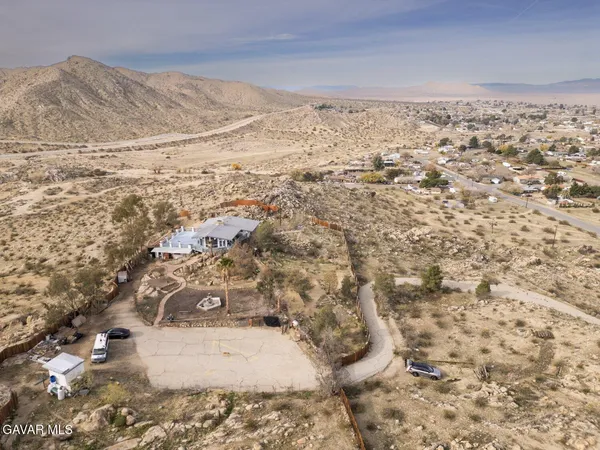 a hallway with wooden floor and a couch