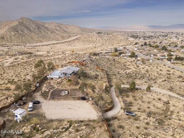 a hallway with wooden floor and a couch