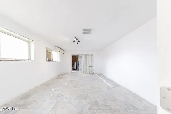 wooden floor in an empty room with a mirror