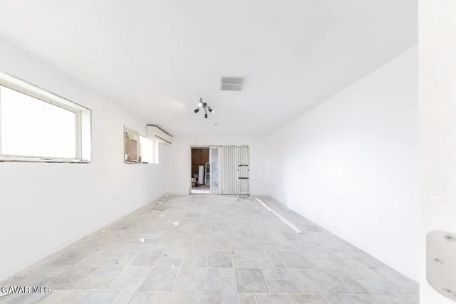 wooden floor in an empty room with a mirror