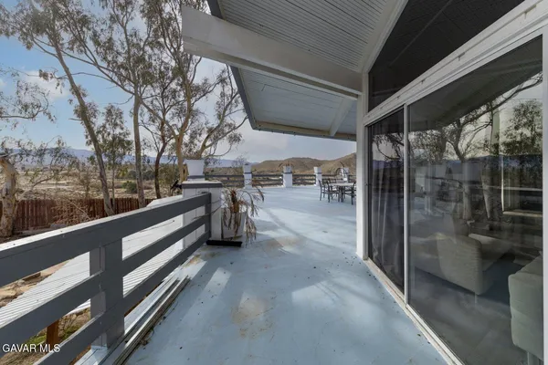 a view of a backyard with a table and chairs
