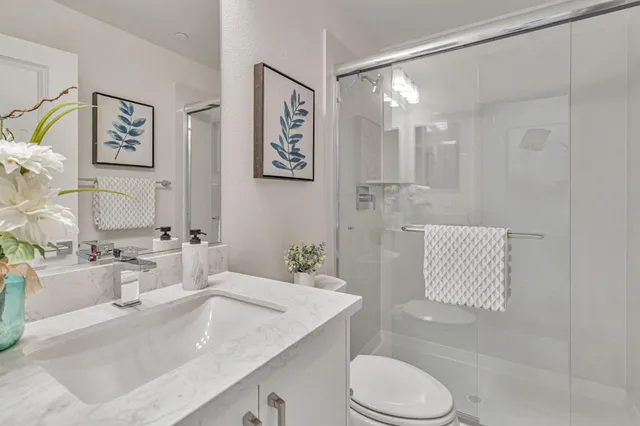 a bathroom with a sink toilet and shower