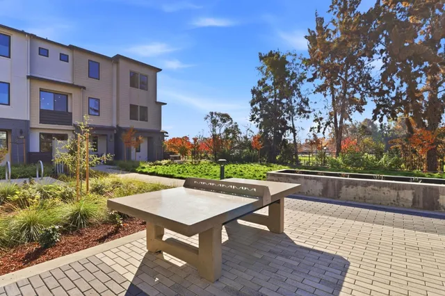 a view of a patio with couches table and chairs and potted plants