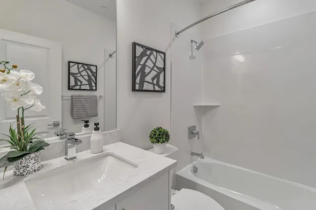 a bathroom with a tub sink and mirror