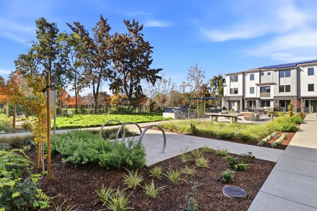a view of a house with garden and sitting area