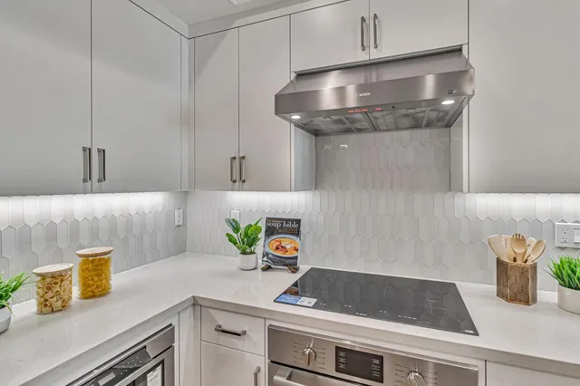 a kitchen with a sink and a stove with cabinets