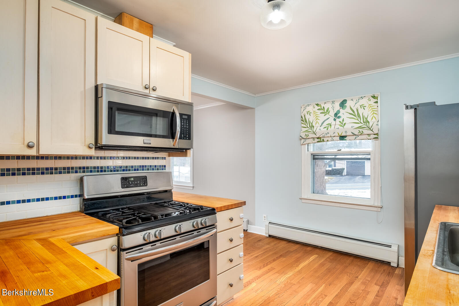 24 Henderson Road Williamstown, MA 01267 - Photo 3 of 17 a kitchen with stainless steel appliances a stove a microwave and cabinets