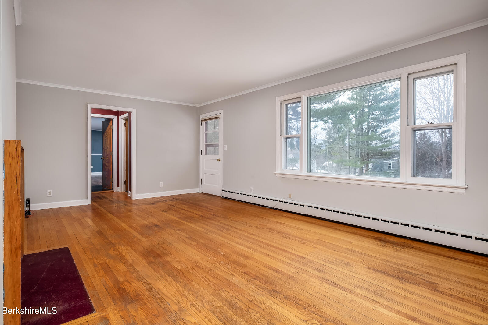24 Henderson Road Williamstown, MA 01267 - Photo 6 of 17 a view of an empty room with a window and wooden floor