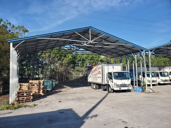 a view of patio with table and chairs under an umbrella