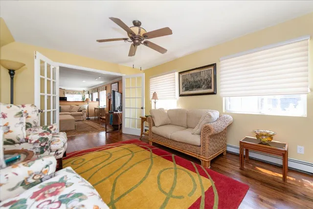 a living room with furniture and a wooden floor