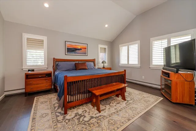 a bedroom with furniture and a flat screen tv
