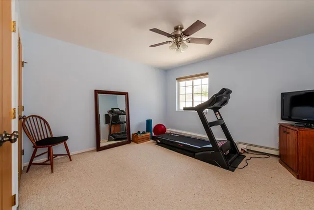 a room with gym equipment and a wooden floor
