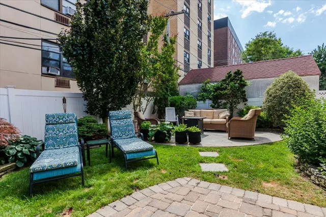 a view of a patio with couches table and chairs and potted plants